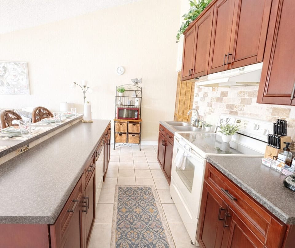 Bright, fully equipped kitchen with modern appliances, ample counter space, and stylish cabinetry—perfect for cooking and entertaining during your stay.