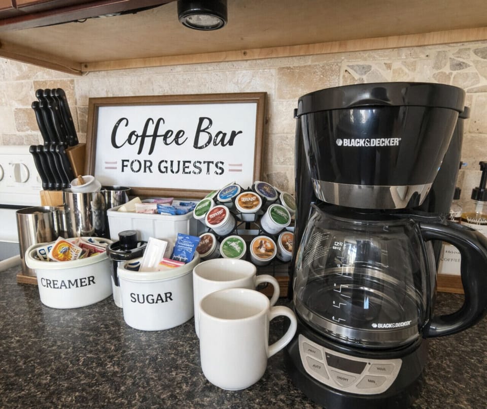 Fully stocked in-unit coffee bar with drip coffee maker, pods, creamer, and sugar—perfect for your morning lake getaway routine.