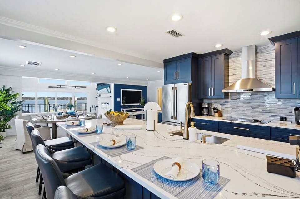 The open concept kitchen is fully stocked and perfect for preparing meals during your stay.