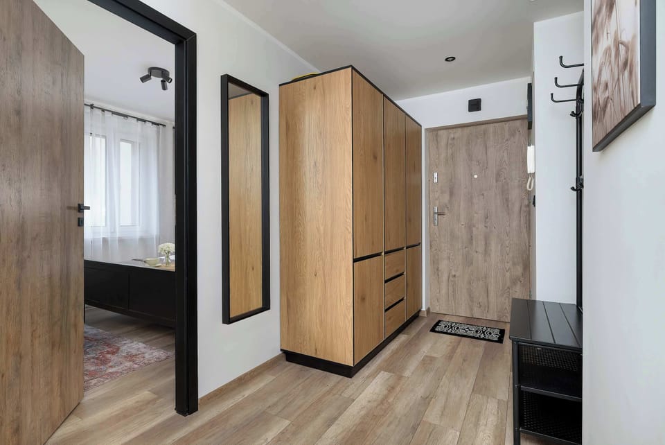 The hallway includes a large wooden wardrobe providing ample storage space for guests' belongings.