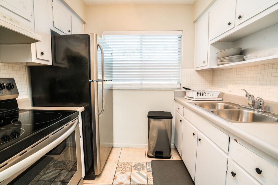 Your fully equipped galley kitchen features everything needed for home cooking, from stainless steel appliances to ample counter space for meal prep.