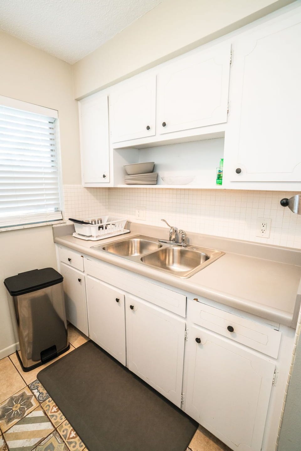 Your bright kitchen features everything you need: double sink, ample cabinets, and natural light for comfortable meal prep.