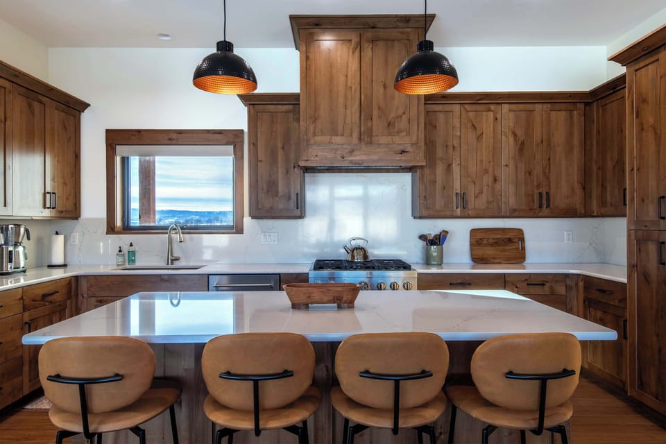 Fully equipped kitchen with island seating and modern appliances.
