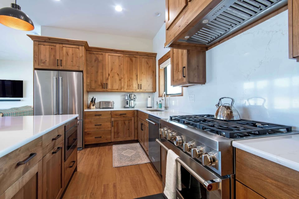 Fully equipped kitchen with island seating and modern appliances.