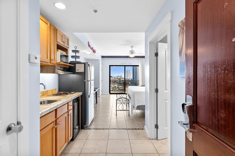 Step into your modern studio where the fully equipped kitchen flows seamlessly into your living space, complete with city views.