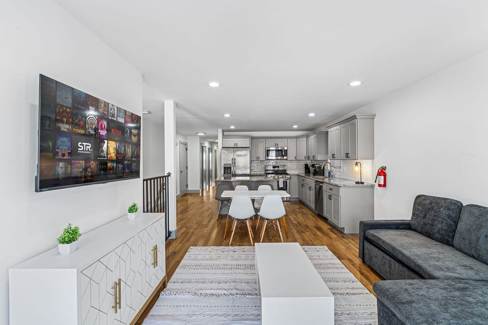 Bright, open-concept main living space designed for longer stays. The layout connects the living room, dining area, and full kitchen seamlessly, giving guests room to spread out, work, cook, and relax without feeling cramped. Ideal for roommates or f