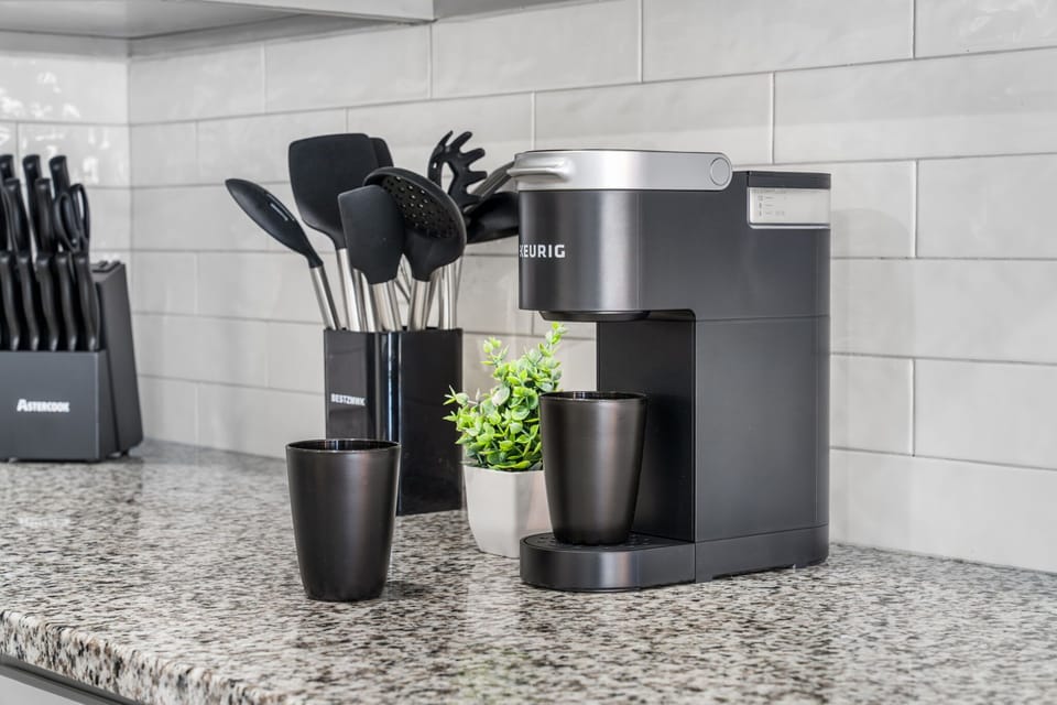 Dedicated coffee station with Keurig setup. A practical touch for busy mornings before work. Perfect for midterm guests who appreciate convenience and daily routines.