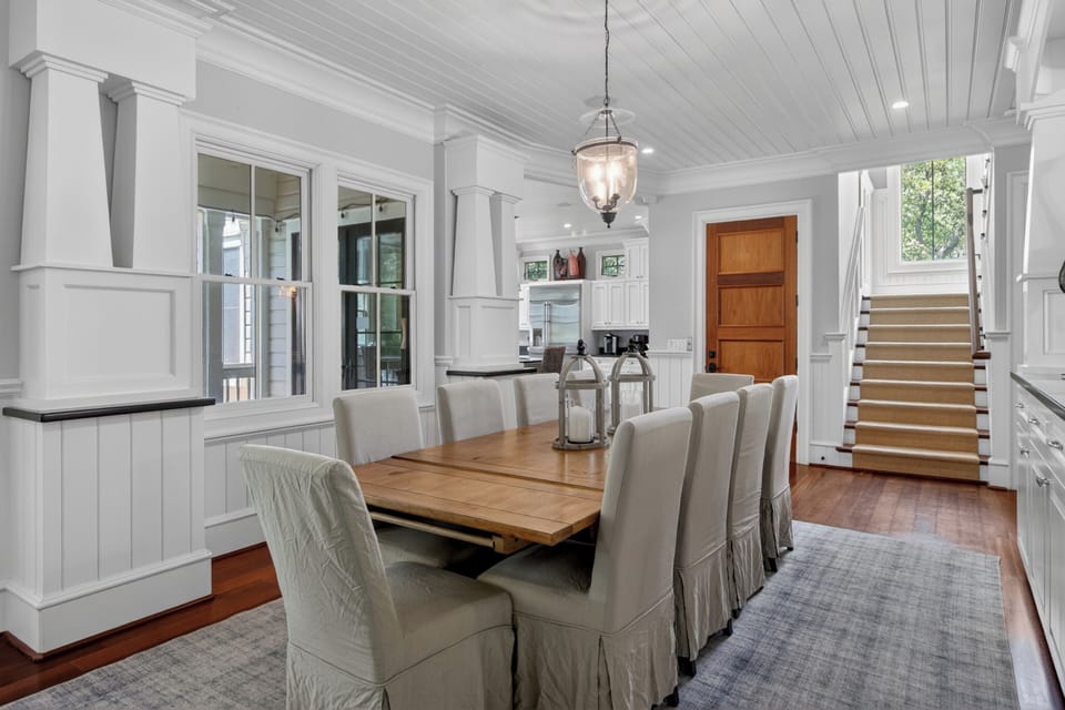 Gather around this beautiful farmhouse dining table where warm wood tones meet crisp white details, creating the perfect setting for memorable meals.