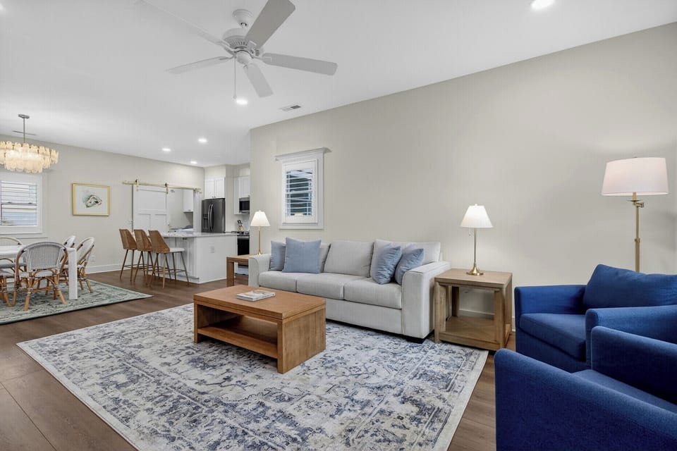 Relax in your spacious open living area with plush seating, elegant lighting, and a fully equipped kitchen perfect for your getaway.
