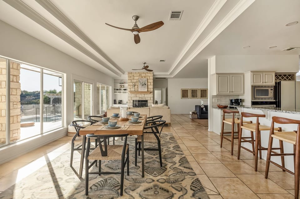Dining table for 6 guests with additional seating on the kitchen top