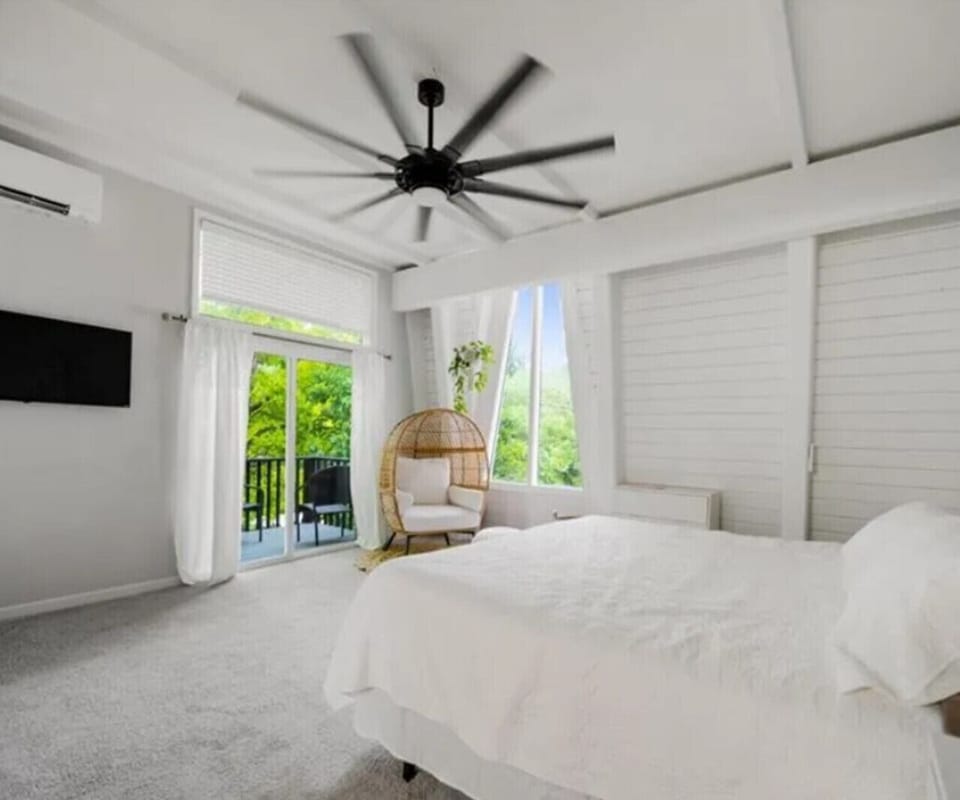 Spacious and serene bedroom with hardwood floors, private balcony access, and beautiful natural light!