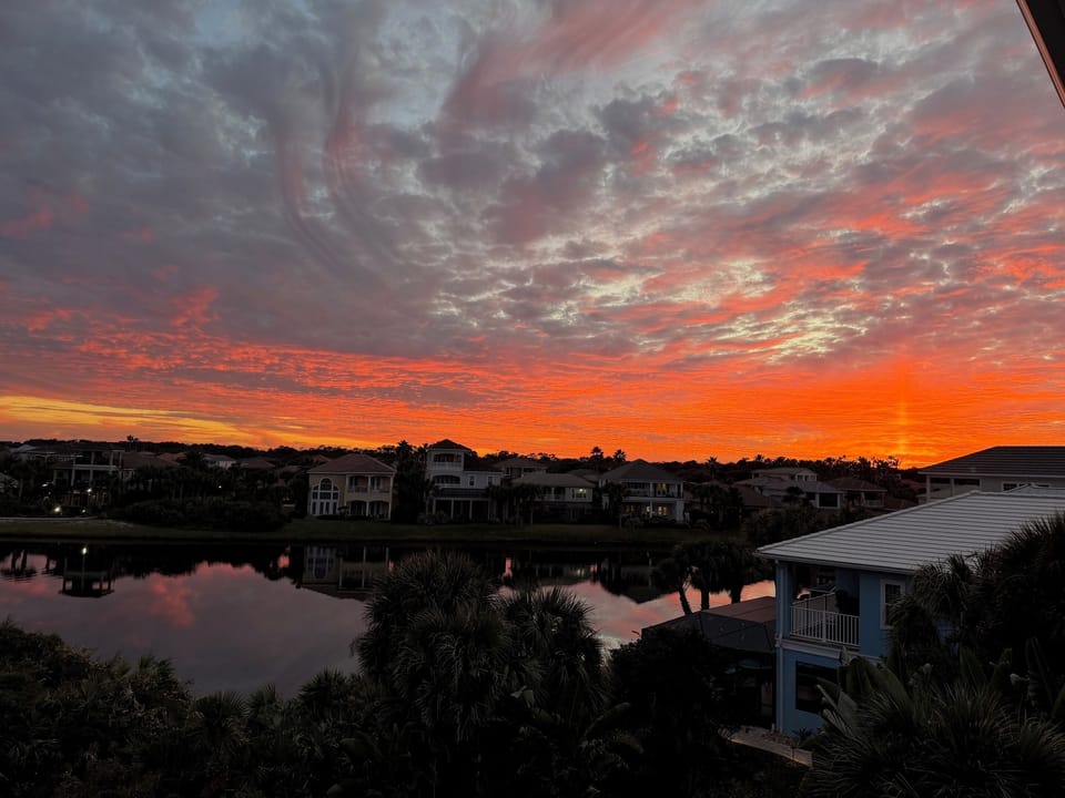Everyone ends up on the balcony when the sky does this. The lake turns to glass, the horizon catches fire, and the kids go quiet for once—then you all laugh about it later, like you planned the perfect ending to the day.
