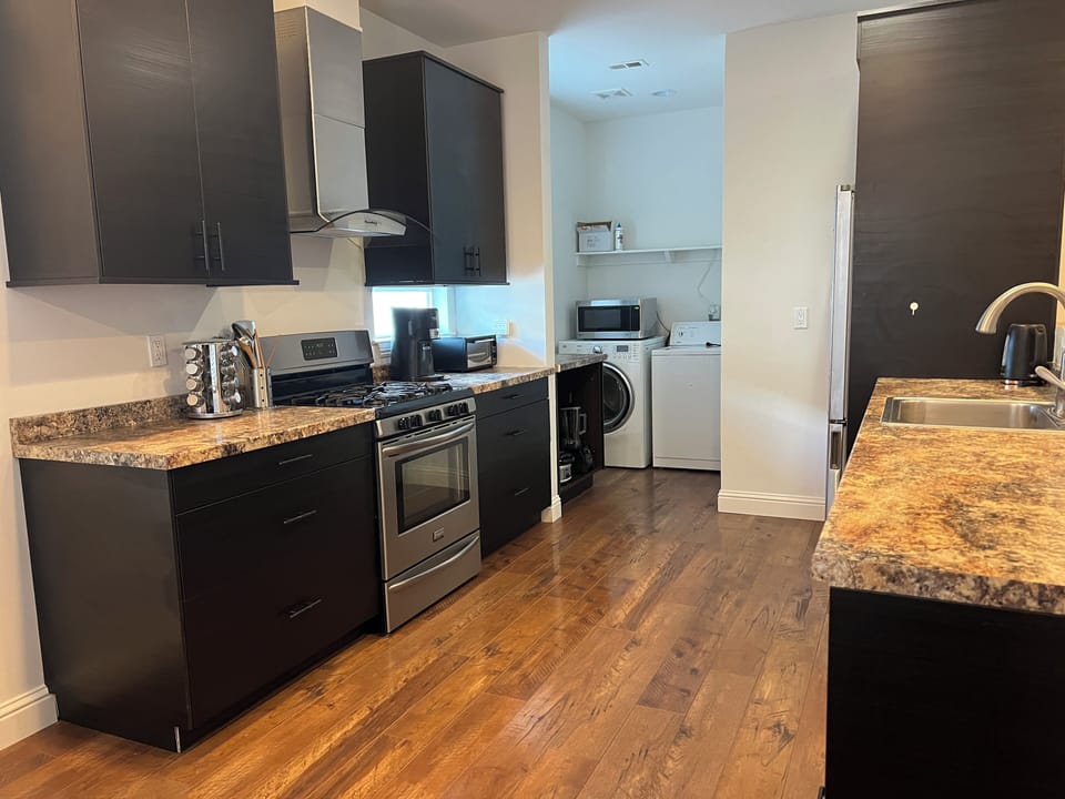 Clean & spacious kitchen with upscale appliances & laundry.