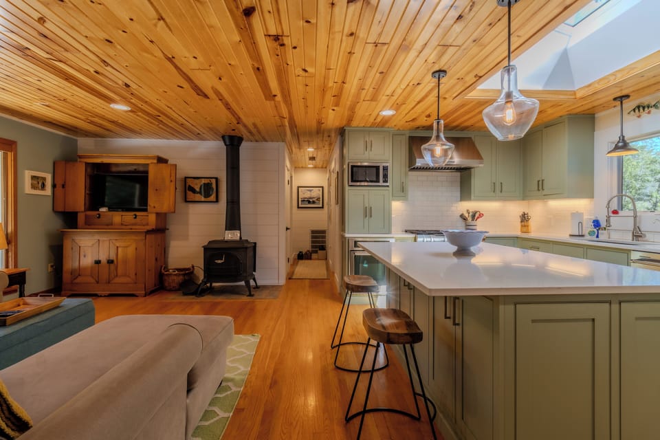 Living Area - Woodstove is not for use. Shown center is the hallway to two of the bedrooms and the main bathroom.