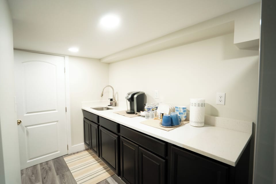 Convenient kitchenette with fridge and complimentary treats, coffee, and water.