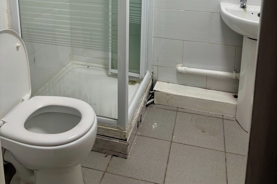 Shower, hair dryer, towels, toilet paper