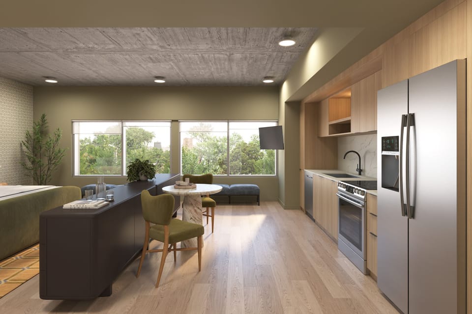 A bright, open-concept kitchen and dining area featuring stainless steel appliances.