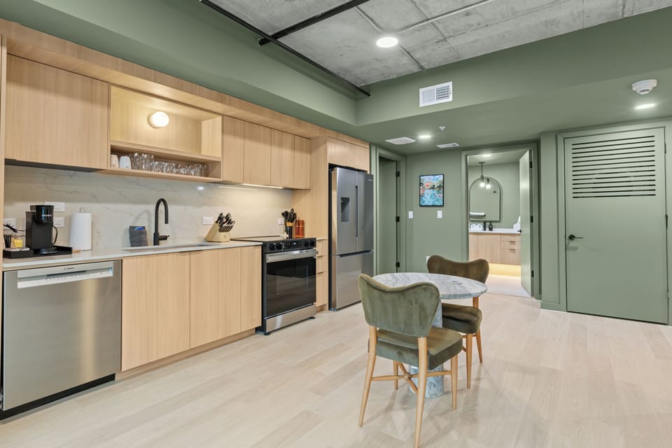 Whip up meals with ease in the sleek full kitchen featuring modern appliances, ample prep space, and a cozy dining nook.