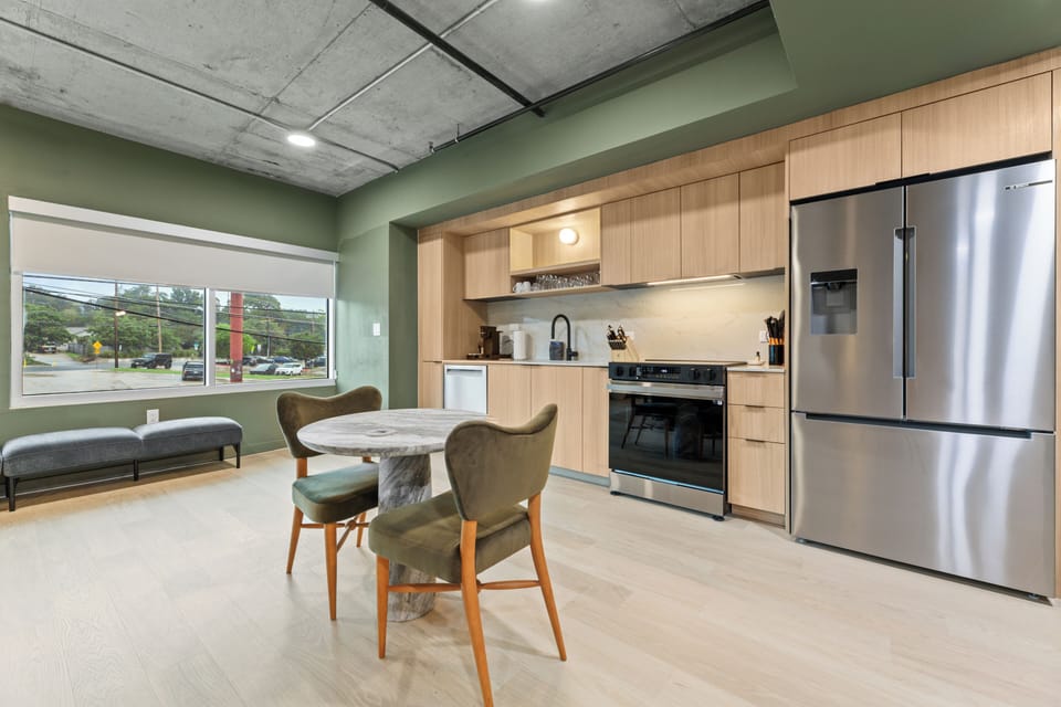 Whip up meals with ease in the sleek full kitchen featuring modern appliances, ample prep space, and a cozy dining nook.