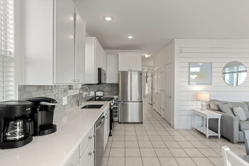 Bright, fully equipped first-floor kitchen with stainless steel appliances, ample counter space, and everything you need for easy meals between beach days.