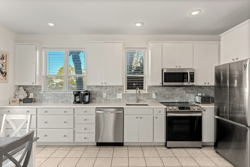 Bright, fully equipped first-floor kitchen with stainless steel appliances, ample counter space, and everything you need for easy meals between beach days.