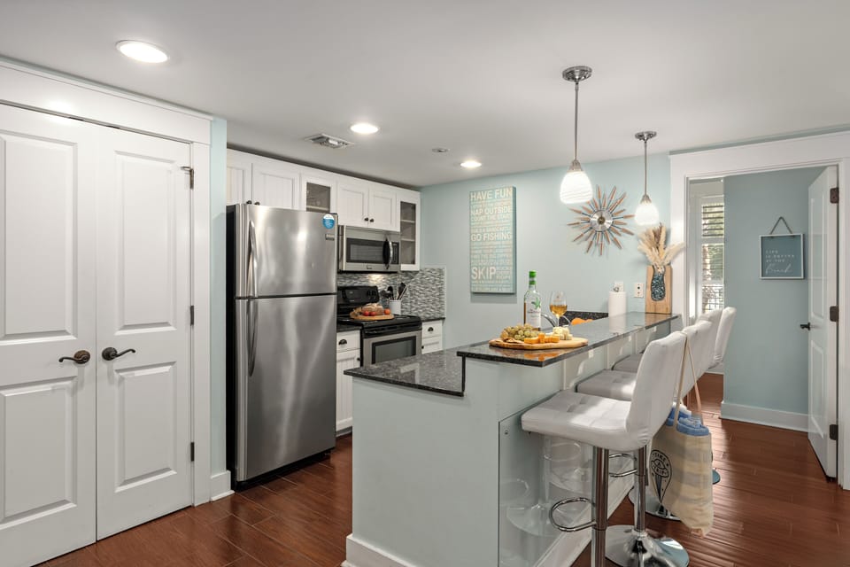 Open-concept kitchen with modern appliances and bar seating.