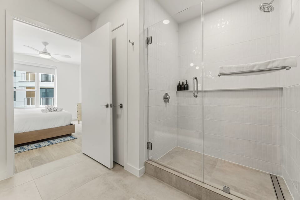Walk-in glass shower with updated tile work and premium finishes.