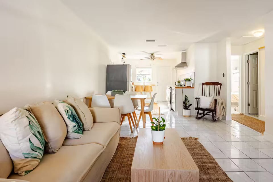 Relax in this bright and airy living room with a comfortable sofa, cozy armchairs, and soft neutral décor. Enjoy a convenient dining area ideal for meals, games, or getting work done on the go.