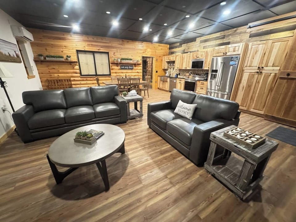 Spacious living area with smart TV, dining room table, and fully stocked kitchen.