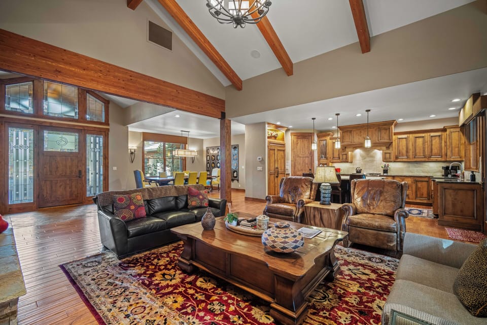 Unwind in this stunning open-concept living space where rustic wood beams meet modern comfort, perfect for gathering with loved ones.