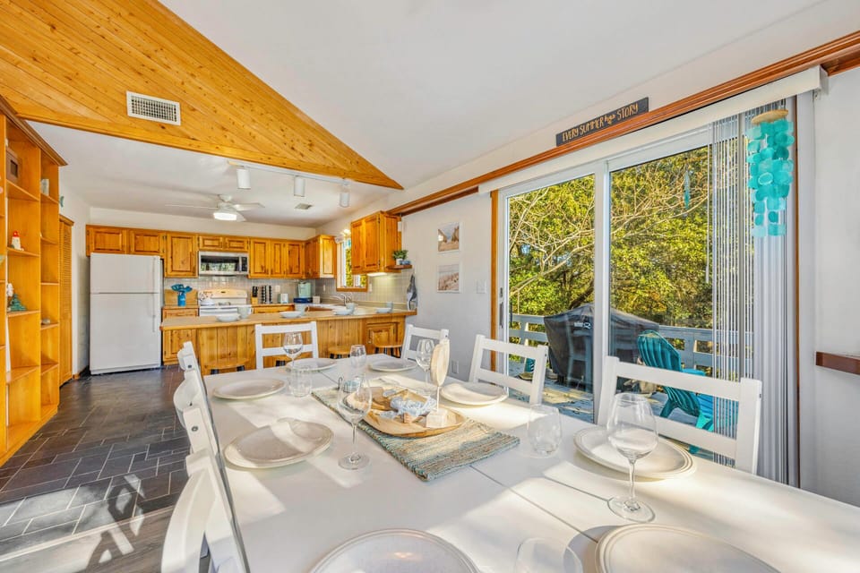 Gather around your dining table where natural light streams in, creating perfect moments for shared meals with garden views.