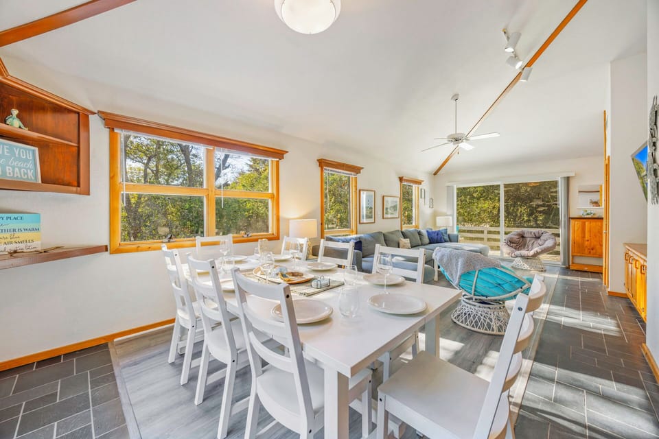 Gather around your spacious dining table where natural light streams through wood-trimmed windows, creating the perfect setting for memorable meals with loved ones.