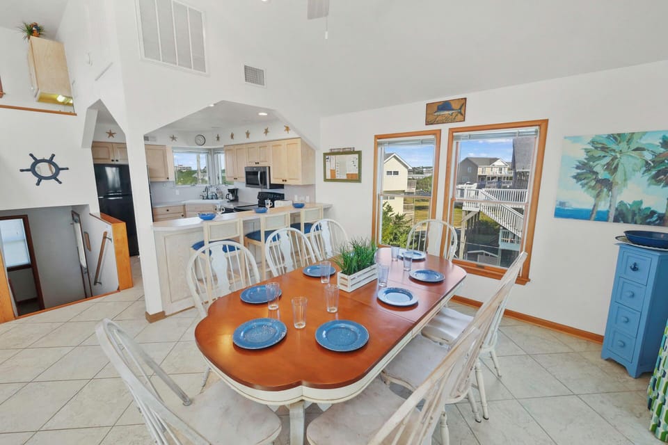 Your dining space awaits with a beautifully set table for memorable meals, while the open kitchen invites culinary adventures.