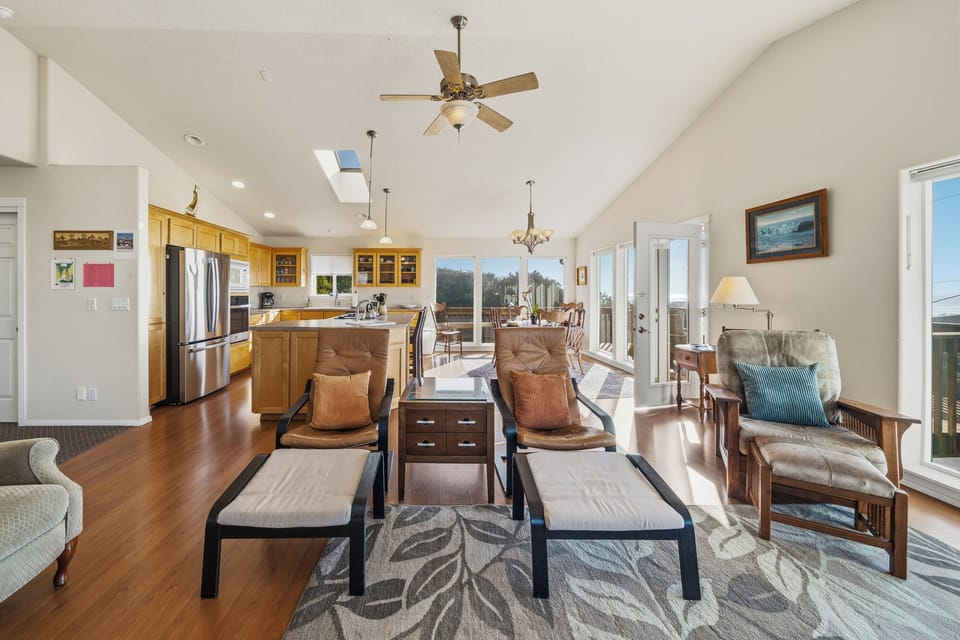 Living room is open to both dining area and fully equipped kitchen with ocean views.
