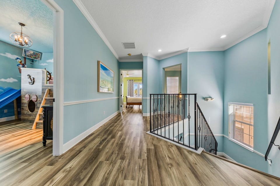 “Bright upstairs hallway connecting the bedrooms, game room, and theater, designed for easy flow and access to all the fun.”