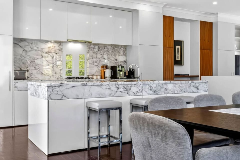 Sleek kitchen with marble backsplash and appliances