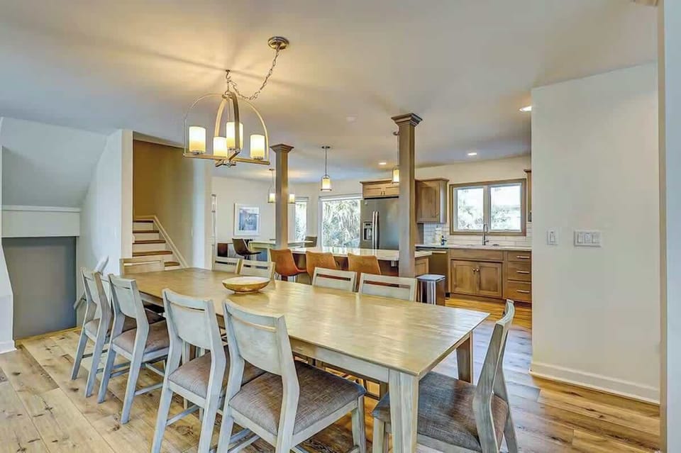 Gather around the spacious dining table where your group can share meals and make memories in this open-concept living space.