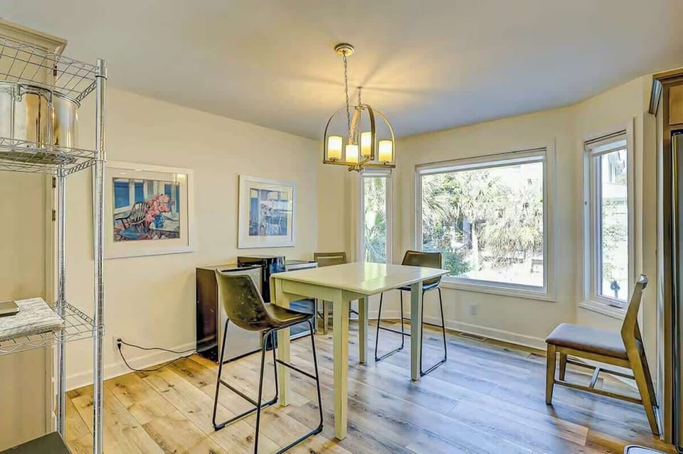 Gather around your bright dining table with garden views streaming through large windows, creating the perfect spot for morning coffee and evening meals.
