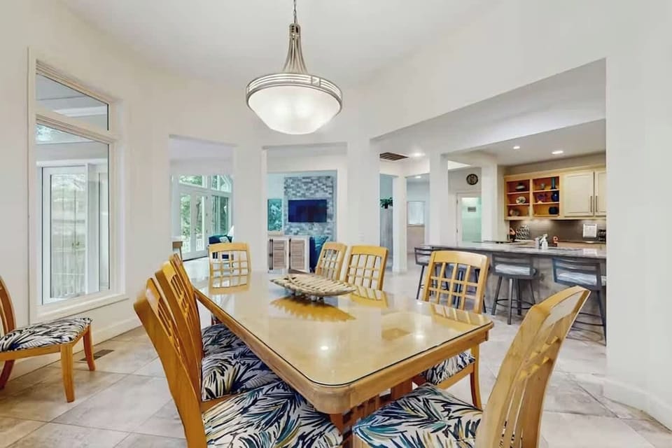 Gather around your spacious dining table for memorable meals while natural light streams through oversized windows and the modern kitchen awaits.