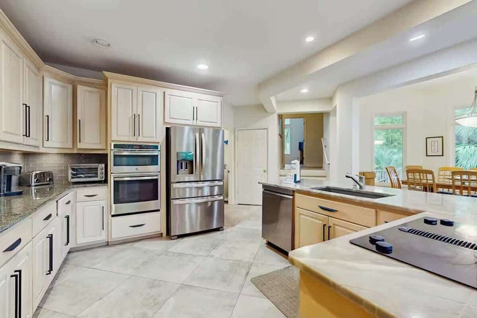 Your gourmet kitchen awaits with granite countertops, stainless steel appliances, and spacious island perfect for cooking together.