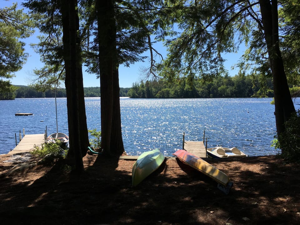 Peaceful lakefront setting with kayaks and dock ready for your waterfront adventures.