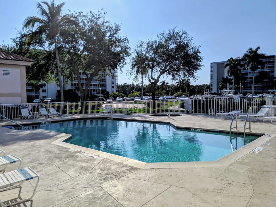 Dive into crystal-clear waters surrounded by tropical palms and comfortable loungers in your own poolside paradise.