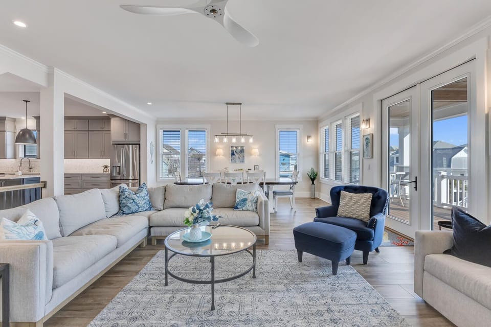 Settle into this bright, open living space where plush seating and modern comfort create your perfect home base for coastal adventures.