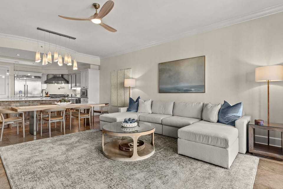 Sink into this plush sectional sofa where coastal blues meet modern comfort, perfect for movie nights in your stylish open-plan retreat.