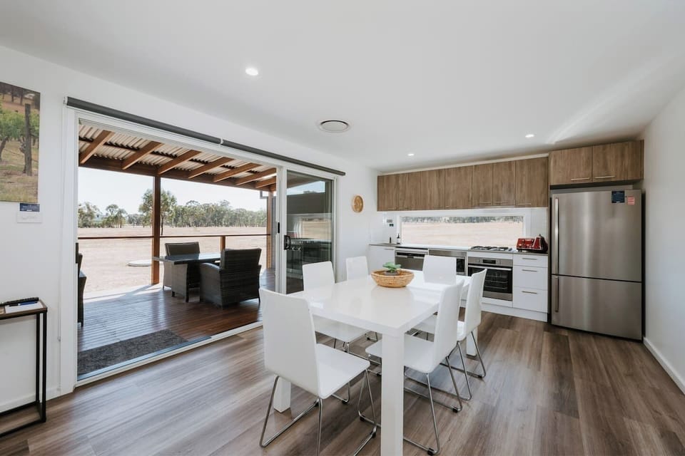 Gather around the six-seater dining table and enjoy shared meals while taking in the peaceful views.