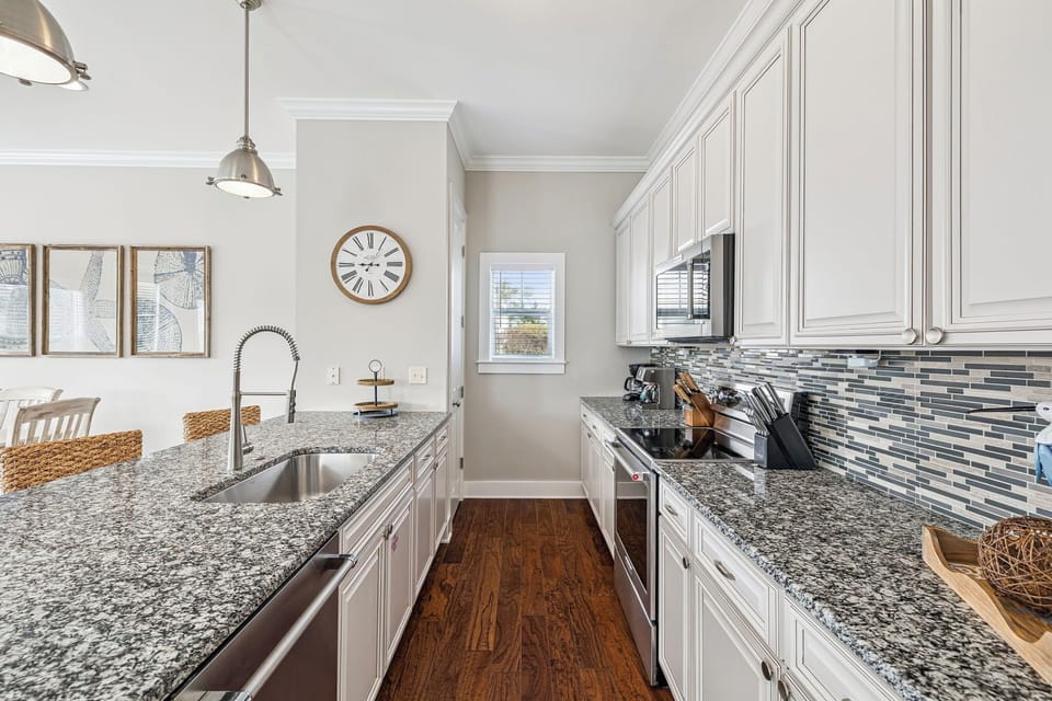 Kitchen features granite countertops, stainless appliances, and a breakfast bar