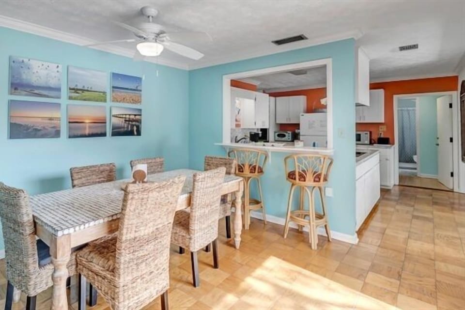 Sun-filled dining area with seating for everyone, seamlessly connected to the kitchen.