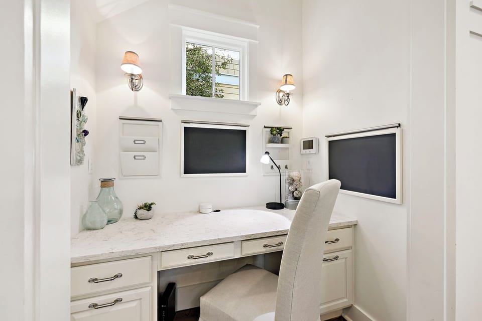 Settle into your elegant workspace featuring dual monitors, marble countertops, and warm lighting—perfect for productive mornings or quiet evenings.