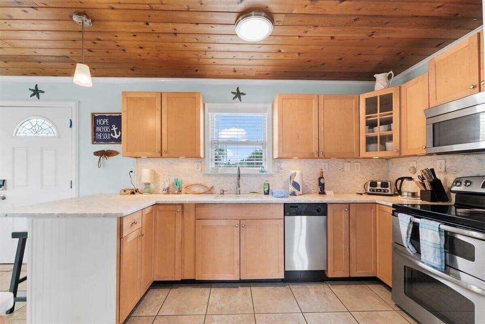 Fully equipped kitchen with modern appliances and plenty of counter space for preparing beach day meals.