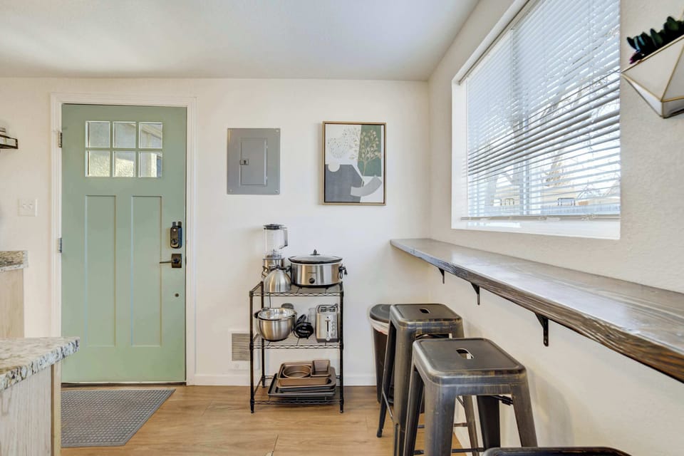 Enjoy your morning coffee at the breakfast bar, which features three stools set against a window overlooking the backyard. It’s a bright, functional spot to start your day before heading out to explore.